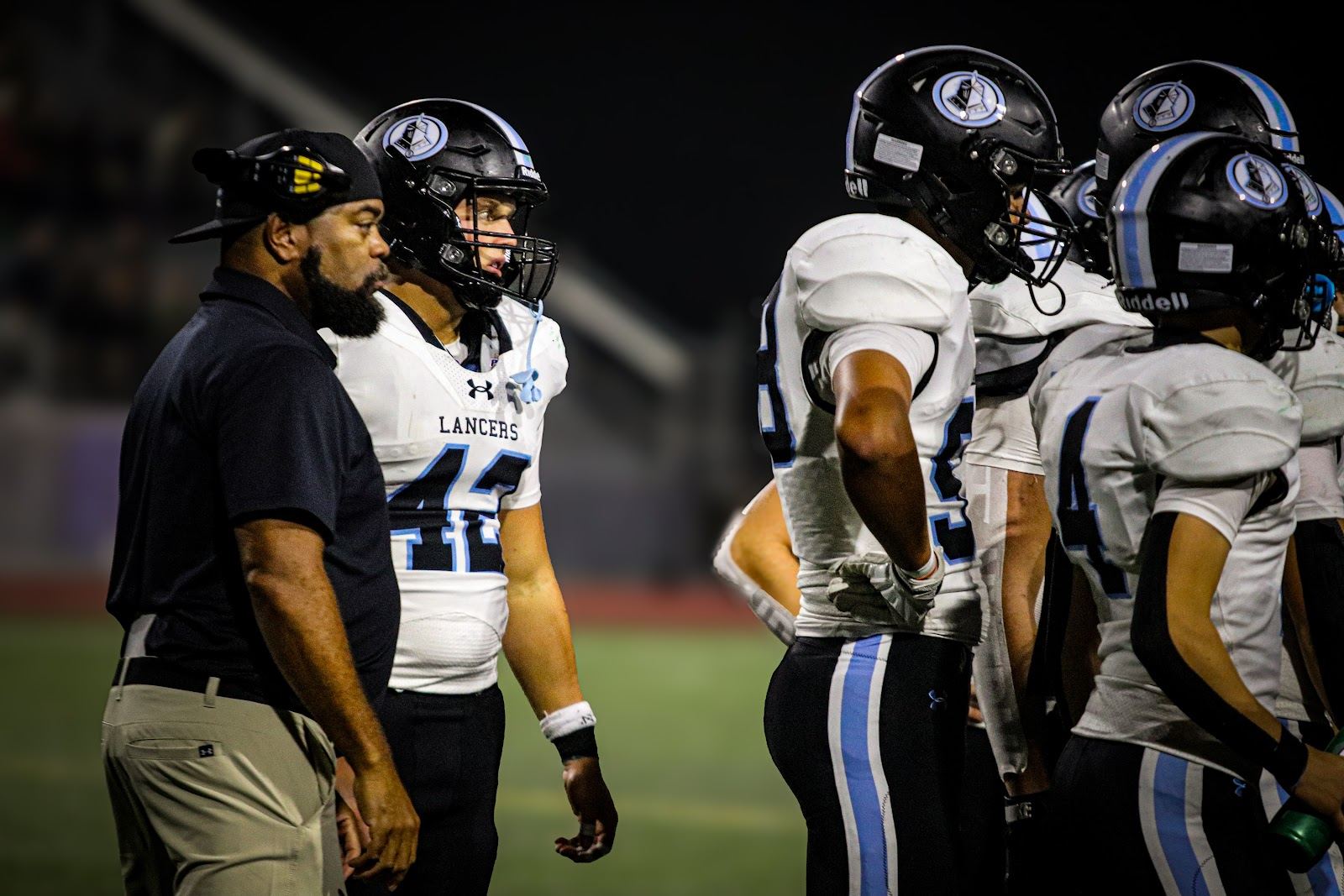 SME @ SM South — Lancers gather with a coach on the sideline